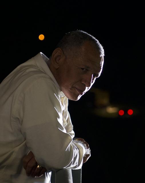 NASA Administrator Charles Bolden looks at the large crowds gathered from atop of the Mobile Launch Platform (MLP) as the space shuttle Atlantis (STS-135) rolls out of High Bay 3 in the Vehicle Assembly Building to Launch Pad 39a for its final flight, Tuesday evening, May 31, 2011, at Kennedy Space Center in Cape Canaveral, Fla. The 3.4-mile trek, known as "rollout," will take about seven hours to complete. Atlantis will carry the Raffaello multipurpose logistics module to deliver supplies, logistics and spare parts to the International Space Station. The launch of STS-135 is targeted for July 8. Photo Credit: (NASA/Bill Ingalls)