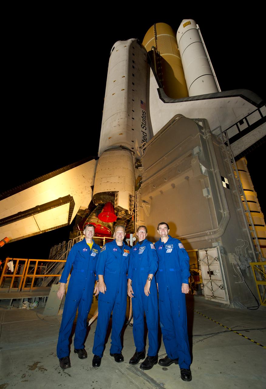 STS-135 crew members Chris Ferguson, left, Douglas Hurley, second from left, Sandra Magnus, and Rex Walheim, right, pose for a group photograph atop of the Mobile Launch Platform (MLP) as the space shuttle Atlantis (STS-135) rolls out of High Bay 3 in the Vehicle Assembly Building to Launch Pad 39a for its final flight, Tuesday evening, May 31, 2011, at Kennedy Space Center in Cape Canaveral, Fla. The 3.4-mile trek, known as "rollout," will take about seven hours to complete. Atlantis will carry the Raffaello multipurpose logistics module to deliver supplies, logistics and spare parts to the International Space Station. The launch of STS-135 is targeted for July 8. Photo Credit: (NASA/Bill Ingalls)