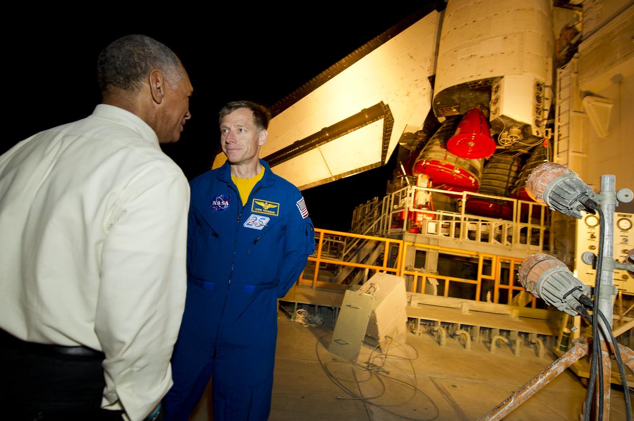 STS-135 Commander Chris Ferguson, right, talks with NASA Administrator Charles Bolden atop of the Mobile Launch Platform (MLP) as the space shuttle Atlantis (STS-135) rolls out of High Bay 3 in the Vehicle Assembly Building to Launch Pad 39a for its final flight, Tuesday evening, May 31, 2011, at Kennedy Space Center in Cape Canaveral, Fla. The 3.4-mile trek, known as "rollout," will take about seven hours to complete. Atlantis will carry the Raffaello multipurpose logistics module to deliver supplies, logistics and spare parts to the International Space Station. The launch of STS-135 is targeted for July 8. Photo Credit: (NASA/Bill Ingalls)