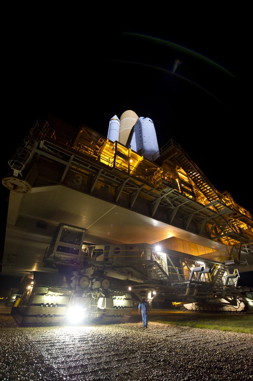 Space Shuttle Atlantis (STS-135) is seen atop the Mobile Launch Platform (MLP) during its journey from High Bay 3 in the Vehicle Assembly Building to Launch Pad 39a for its final flight, Tuesday evening, May 31, 2011, at Kennedy Space Center in Cape Canaveral, Fla. The 3.4-mile trek, known as "rollout," will take about seven hours to complete. Atlantis will carry the Raffaello multipurpose logistics module to deliver supplies, logistics and spare parts to the International Space Station. The launch of STS-135 is targeted for July 8. Photo Credit: (NASA/Bill Ingalls)