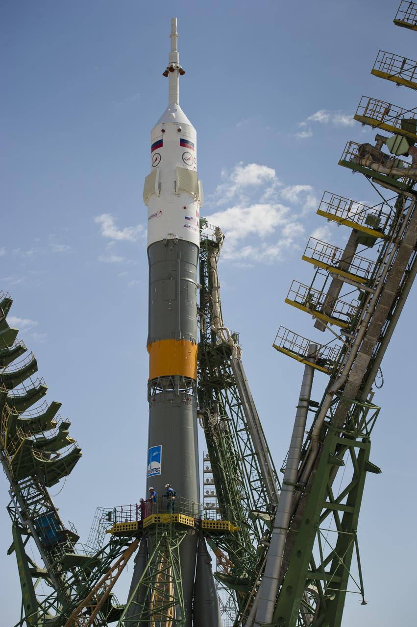 Large gantry mechanisms on either side of the Soyuz TMA-02M spacecraft are raised into position to secure the rocket at the launch pad on Sunday, June 5, 2011 at the Baikonur Cosmodrome in Kazakhstan.  Photo Credit:  (NASA/Carla Cioffi)