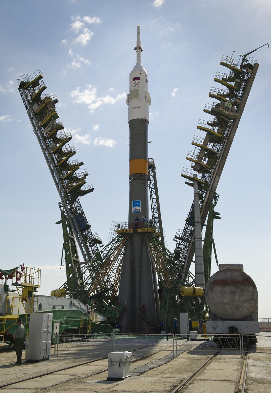 Large gantry mechanisms on either side of the Soyuz TMA-02M spacecraft are raised into position to secure the rocket at the launch pad on Sunday, June 5, 2011 at the Baikonur Cosmodrome in Kazakhstan.  Photo Credit:  (NASA/Carla Cioffi)
