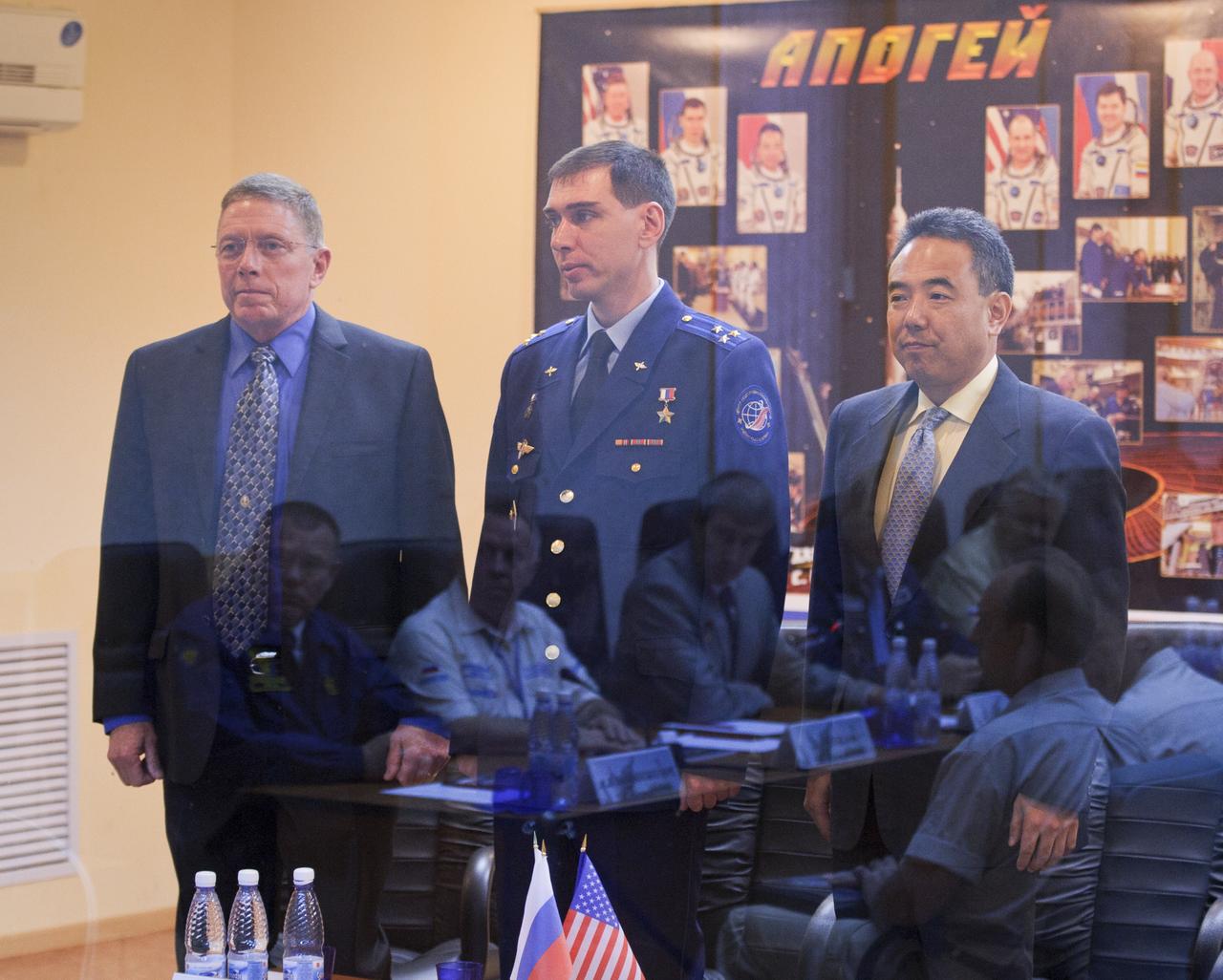 Expedition 28 Soyuz Commander Sergei Volkov, center, stands with NASA Flight Engineer Mike Fossum, left, and Japan Aerospace Exploratin Agency (JAXA) Flight Engineer Satoshi Furukawa during the State Commission meeting to approve the Soyuz launch of Expedition 28 to the International Space Station, Monday, June 6, 2011, at the Cosmonaut Hotel in Baikonur, Kazakhstan. The mission is set to launch on Tuesday, June 8, from the Baikonur Cosmodrome. Photo Credit: (NASA/Carla Cioffi)