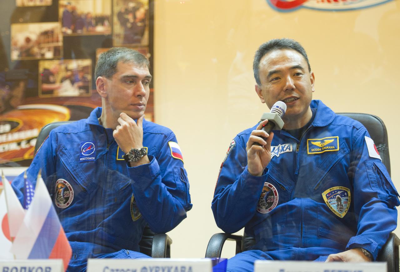 Expedition 28 Japan Aerospace Exploration Agency (JAXA) Flight Engineer Satoshi Furukawa, right, speaks as Soyuz Commander Sergei Volkov of Russia looks on during a press conference, Monday, June 6, 2011, at the Cosmonaut Hotel in Baikonur, Kazakhstan. The mission is set to launch on Tuesday, June 8, from the Baikonur Cosmodrome. Photo Credit: (NASA/Carla Cioffi)