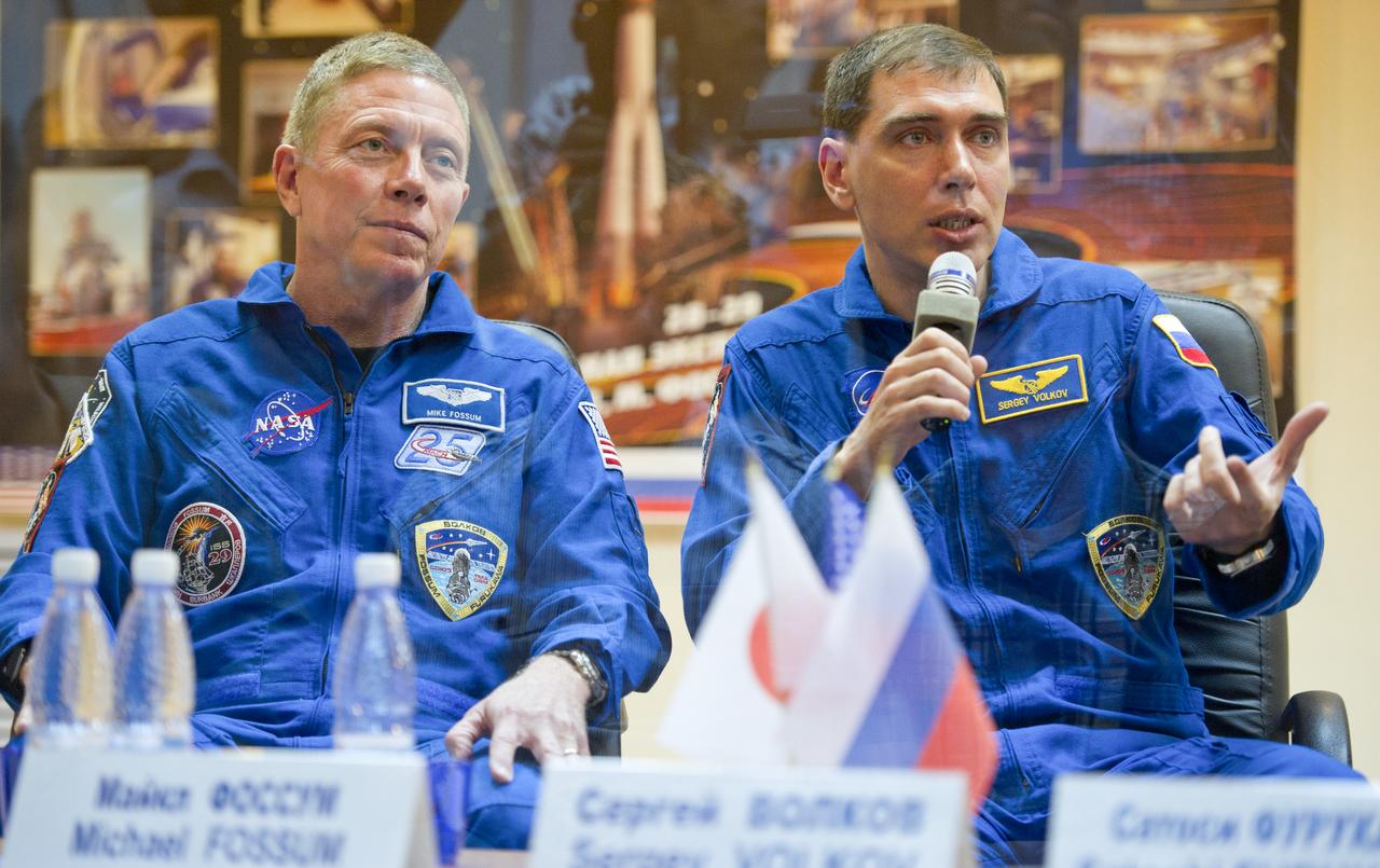 Expedition 28 NASA Flight Engineer Mike Fossum, left, looks on as Soyuz Commander Sergei Volkov speaks during a press conference, Monday, June 6, 2011, at the Cosmonaut Hotel in Baikonur, Kazakhstan. The mission is set to launch on Tuesday, June 8, from the Baikonur Cosmodrome. Photo Credit: (NASA/Carla Cioffi)