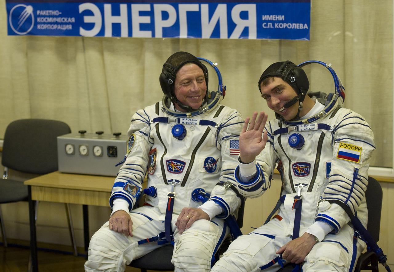 Expedition 28 crew members Soyuz Commander Sergei Volkov of Russia, right, and NASA Flight Engineer Mike Fossum wave after having their Russian Sokol suits pressure checked, Tuesday Jun 7, 2011, in preparation for launch onboard the Soyuz TMA-02M rocket at the Baikonur Cosmodrome in Baikonur, Kazakhstan.  Photo Credit: (NASA/Carla Cioffi)