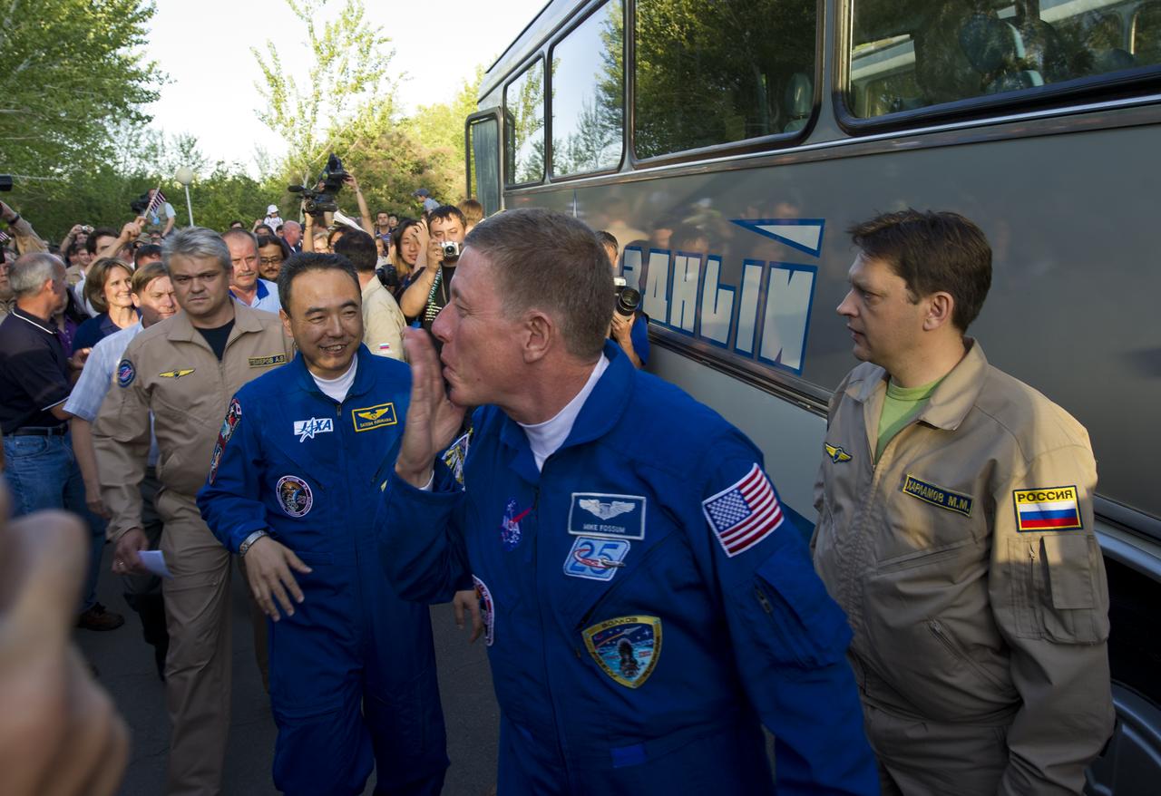 Expedition 28 Flight Engineer and NASA astronaut Mike Fossum blows a kiss to well wishers as he departs the Cosmonaut Hotel on the evening before his Soyuz launch to the International Space Station on Tuesday, June 7, 2011 in Baikonur, Kazakhstan.  Photo Credit:  (NASA/Carla Cioffi)