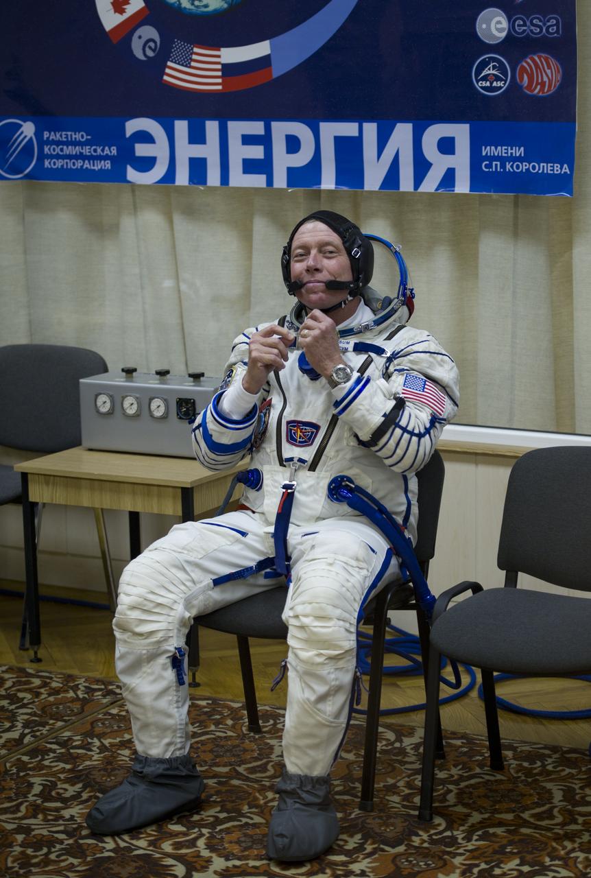 NASA astronaut and Expedition 28 Flight Engineer Mike Fossum awaits to have his Russian Sokol suit pressure checked in preparation for his launch onboard the Soyuz TMA-02M on Tuesday, June 7, 2011 at the Baikonur Cosmodrome in Kazakhstan.  The Soyuz spacecraft will carry Expedition 28 Soyuz Commander Sergei Volkov, JAXA (Japanese Aerospace Exploration Agency) Flight Engineer Satoshi Furukawa and Fossum to the International Space Station.  Photo Credit:  (NASA/Carla Cioffi)