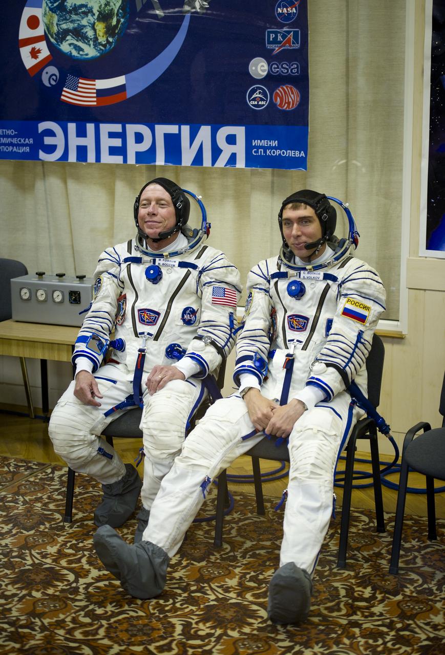 Expedition 28 Soyuz Commander Sergei Volkov, right, and Expedition 28 Flight Engineer and NASA astronaut Mike Fossum sit after having their Russian Sokol suits pressure checked at the Baikonur Cosmodrome in Kazakhstan on Tuesday, June 7, 2011.  The crew of Expedition 28 will launch onboard their Soyuz TMA-02M on the morning of June 8 to the International Space Station.  Photo Credit:  (NASA/Carla Cioffi)