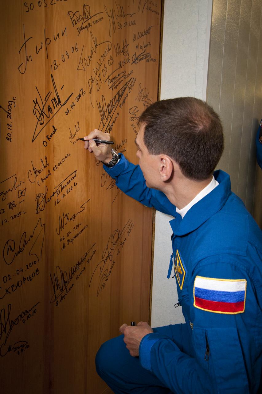 Expedition 28 Soyuz Commander Sergei Volkov performs the traditional door signing Tuesday, June 7, 2011 at the Cosmonaut Hotel in Baikonur, Kazakhstan. Volkov was launched onboard the Soyuz rocket the following morning with Expedition 28 NASA Flight Engineer Mike Fossum and JAXA (Japanase Aerospace Exploration Agency) Flight Engineer Satoshi Furukawa on a mission to the International Space Station (ISS).  Photo Credit: (NASA/Victor Zelentsov)