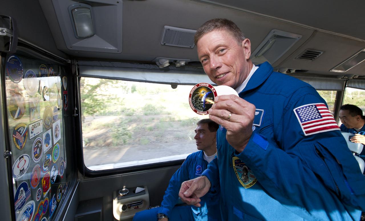 Expedition 28 NASA Flight Engineer displays the Expedition 29 crew sticker while riding on the prime crew bus to Building 254 the eve of his launch to the International Space Station, Tuesday, June June 7, 2011 at the Baikonur Cosmodrome in Kazakhstan.  Fossum will be the ISS Commander for Expedition 29.  Photo Credit: (NASA/Roscosmos/Andrey Shelepin)