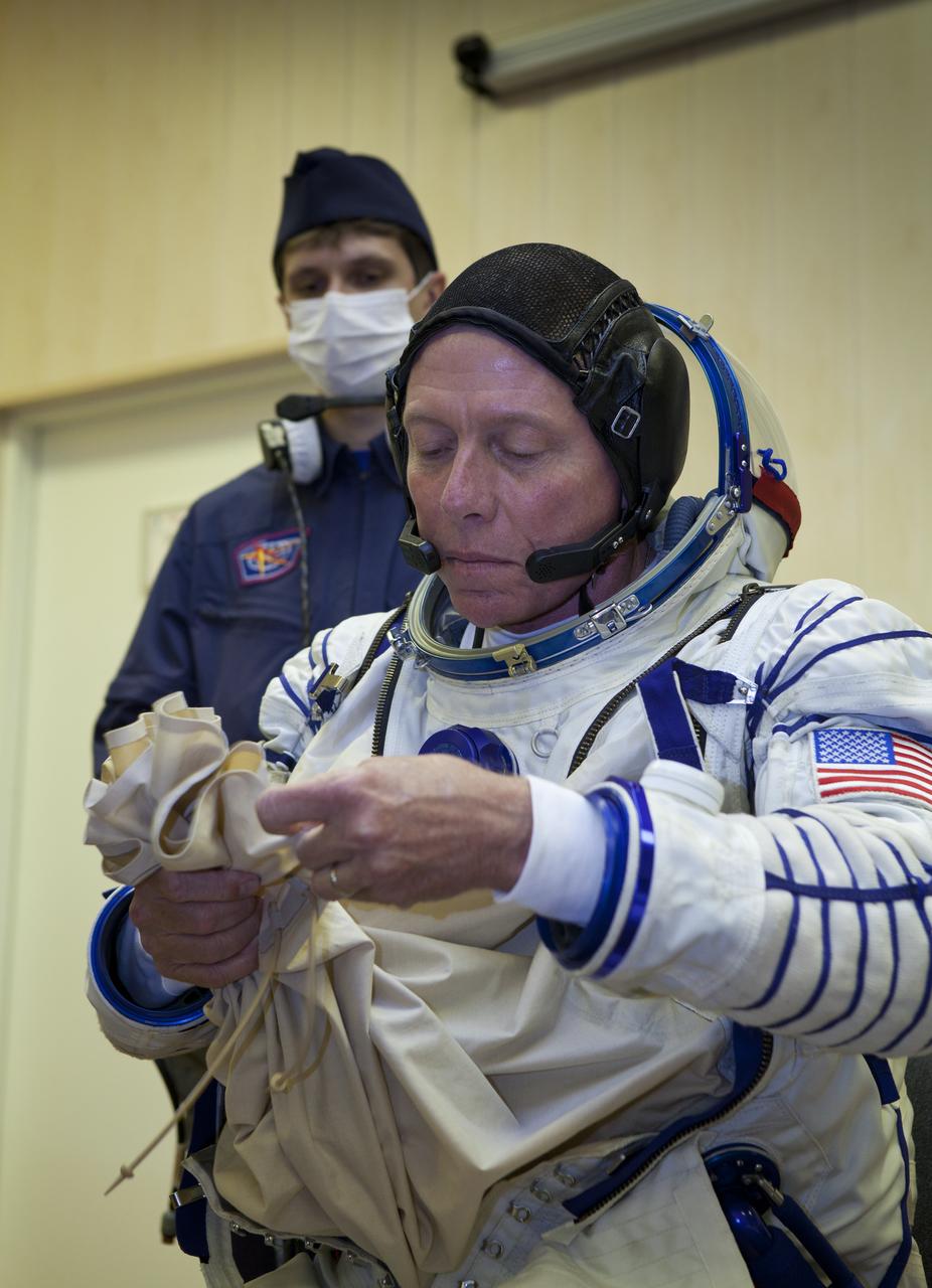 Expedition 28 NASA Flight Engineer Mike Fossum has his Russian Sokol suit prepared for launch at the Baikonur Cosmodrome in Baikonur, Kazakhstan, Tuesday, June 7, 2011.  Fossum and fellow Expedition 28 crew members Soyuz Commander Sergei Volkov and JAXA (Japanase Aerospace Exploration Agency) Flight Engineer Satoshi Furukawa launched in their Soyuz TMA-02M rocket from the Baikonur Cosmodrome in Kazakhstan the following morning on June 8th. Photo Credit: (NASA/Roscosmos/Andrey Shelepin)