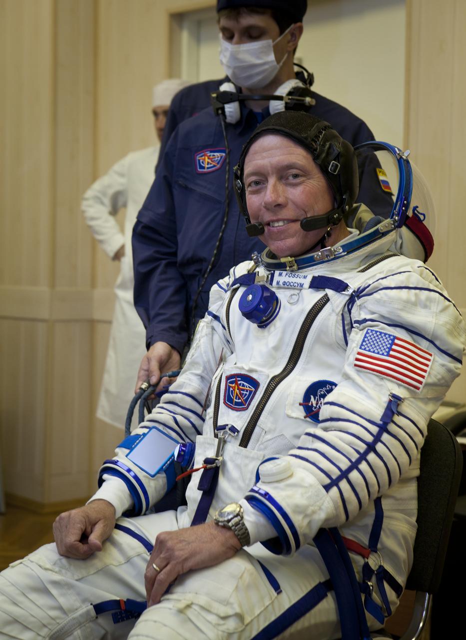 Expedition 28 NASA Flight Engineer Mike Fossum has his Russian Sokol suit prepared for launch at the Baikonur Cosmodrome in Baikonur, Kazakhstan, Tuesday, June 7, 2011.  Fossum and fellow Expedition 28 crew members Soyuz Commander Sergei Volkov and JAXA (Japanase Aerospace Exploration Agency) Flight Engineer Satoshi Furukawa launched in their Soyuz TMA-02M rocket from the Baikonur Cosmodrome in Kazakhstan the following morning on June 8th. Photo Credit: (NASA/Roscosmos/Andrey Shelepin)