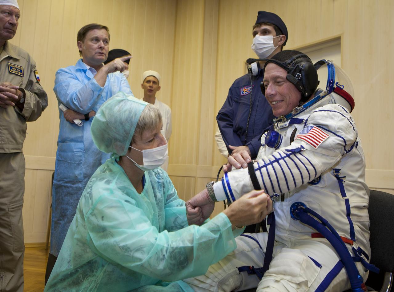 Expedition 28 Flight Engineer Mike Fossum, right, has his Russian Sokol suit checked by Peggy Whitson, Chief of the Astronaut Office at Johonson Space Center, at the Baikonur Cosmodrome in Baikonur, Kazakhstan, Tuesday, June 7, 2011. Fossum and fellow Expedition 28 crew members Soyuz Commander Sergei Volkov and JAXA (Japanase Aerospace Exploration Agency) Flight Engineer Satoshi Furukawa launched in their Soyuz TMA-02M rocket from the Baikonur Cosmodrome in Kazakhstan the following morning on June 8th. Photo Credit: (NASA/Roscosmos/Andrey Shelepin)