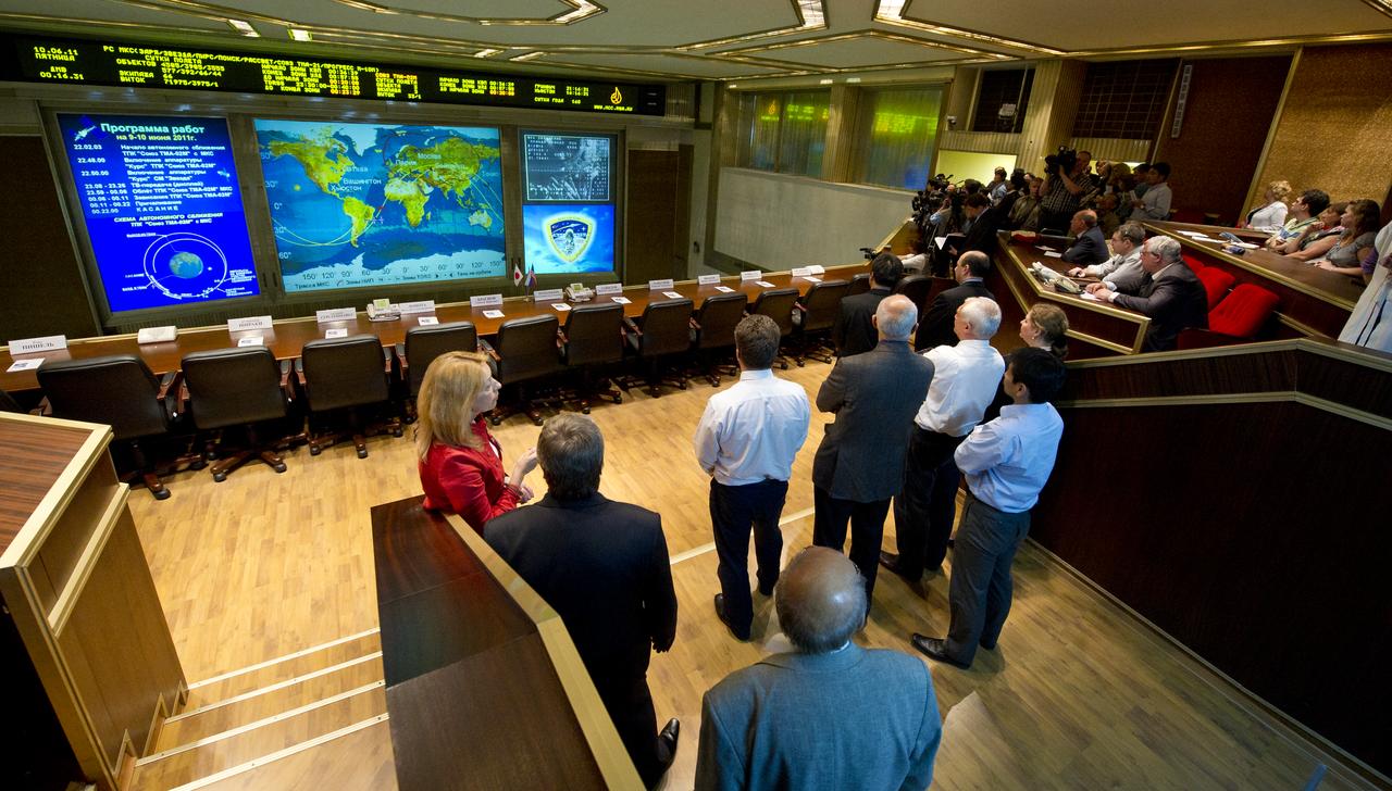 Guests at the Russian Mission Control Center in Korolove, Russia watch on a large screen TV as the Soyuz TMA-02M nears its docking to the International Space Station on Friday, June 10, 2011.  Photo Credit: (NASA/Carla Cioffi)