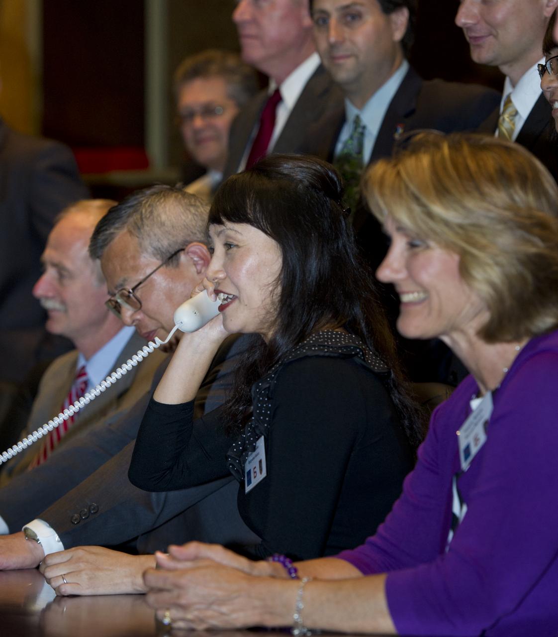 Keiko Furukawa, second from right, wife of Expedition 28 JAXA (Japanase Aerospace Exploration Agency) Flight Engineer Satoshi Furukawa, is seen at Russian Mission Control in Korolev, Russia speaking to her husband shortly after his arrival at the International Space Station on Friday, June 10, 2011. Photo Credit: (NASA/Carla Cioffi)