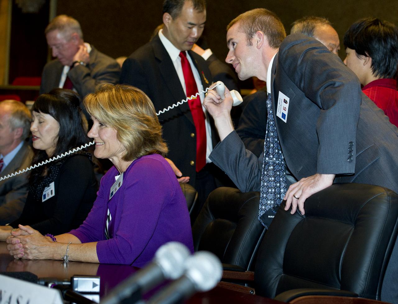 John Fossum, right, son of Expedition 28 NASA Flight Engineer Mike Fossum, is seen at Russian Mission Control in Korolev, Russia speaking to his father shortly after his arrival at the International Space Station on Friday, June 10, 2011. Photo Credit: (NASA/Carla Cioffi)