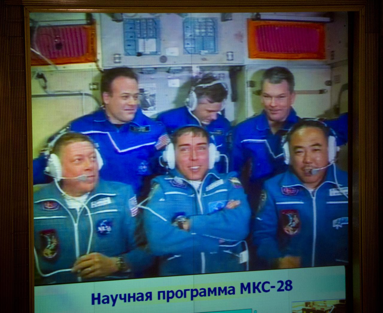 The crews of Expedition 27 and Expedition 28 are seen on a large screen TV at the Russian Mission Control Center in Korolev, Russia shortly after Expedition 28's arrival to the International Space Station on Friday, June 10, 2011.  From top left clockwise: Expedition 27 NASA Flight Engineer Ron Garan, Expedition 27 Russian Flight Engineer Andrey Borisenko, Expedition 27 Commander Alexander Samokutyaev, AXA (Japanase Aerospace Exploration Agency) Flight Engineer Satoshi Furukawa, Expedition 28 Soyuz Commander Sergei Volkov and Expedition 28 NASA Flight Engineer Mike Fossum.  Photo Credit: (NASA/Carla Cioffi)