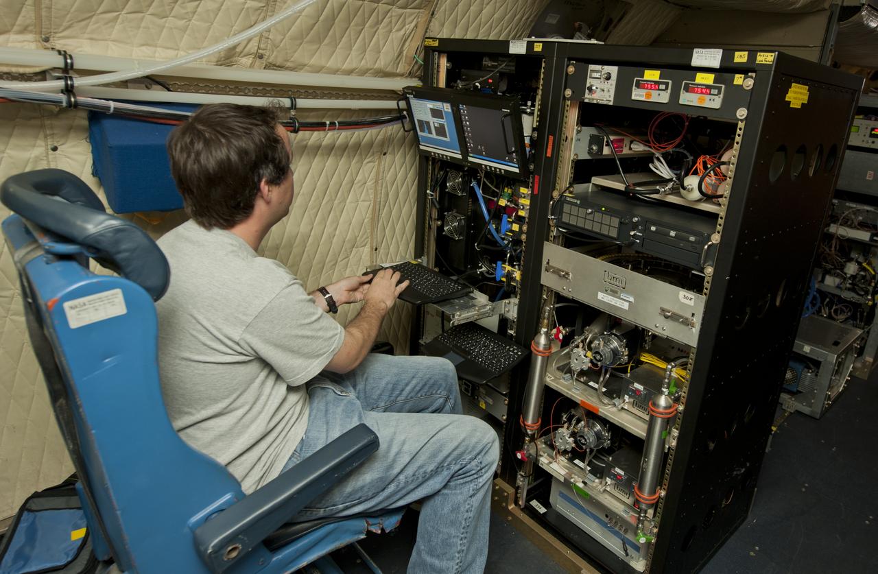 An unidentified researcher works aboard the P-3B NASA research aircraft at Baltimore/Washington International Thurgood Marshall Airport, Tuesday, June 28, 2011, in Baltimore, Md. The aircraft is part of a month-long field campaign designed to improve satellite measurements of air pollution. The name of the experiment -- Deriving Information on Surface conditions from Column and Vertically Resolved Observations Relevant to Air Quality (DISCOVER -- AQ) -- is a mouthful, but its purpose is simple. Come July, the aircraft will be flying spirals over six ground stations in Maryland.  Photo Credit: (NASA/Paul E. Alers)