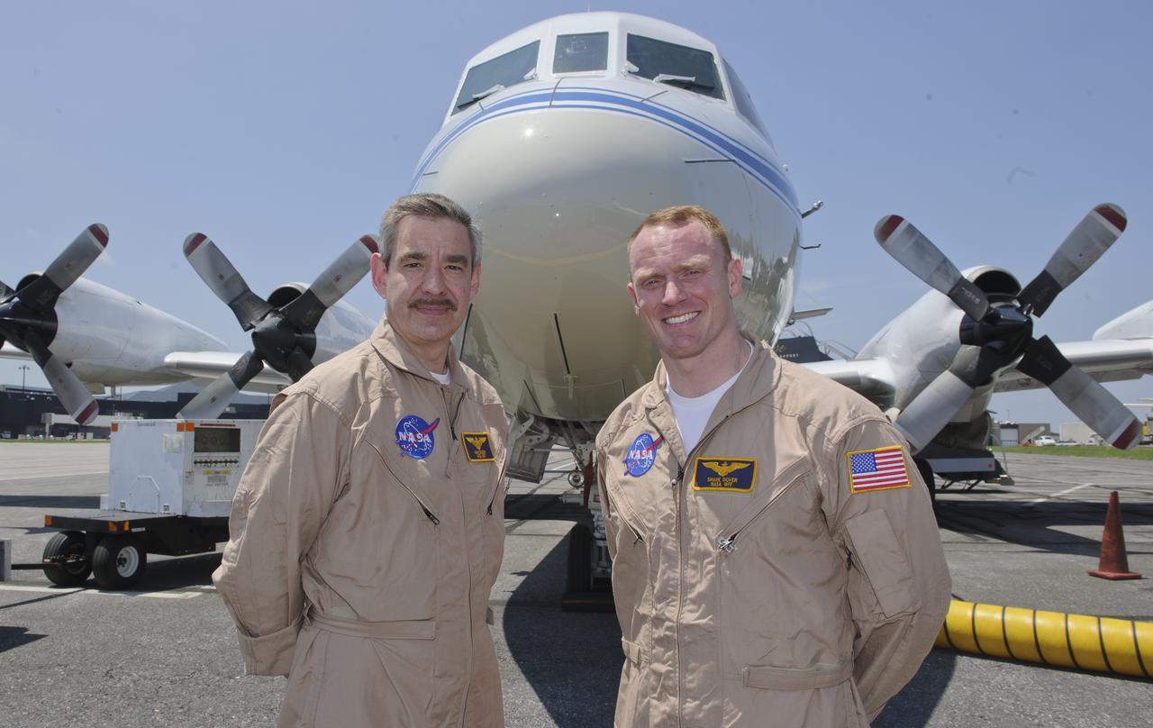 WFF Pilots Mike Singer, left, and Shane Dover stand in front of the 117-foot P-3B NASA research aircraft on the tarmac at Baltimore/Washington International Thurgood Marshall Airport, Tuesday, June 28, 2011, in Baltimore, Md. The aircraft is part of a month-long field campaign designed to improve satellite measurements of air pollution. The name of the experiment -- Deriving Information on Surface conditions from Column and Vertically Resolved Observations Relevant to Air Quality (DISCOVER -- AQ) -- is a mouthful, but its purpose is simple. Come July, the aircraft will be flying spirals over six ground stations in Maryland.  Photo Credit: (NASA/Paul E. Alers)