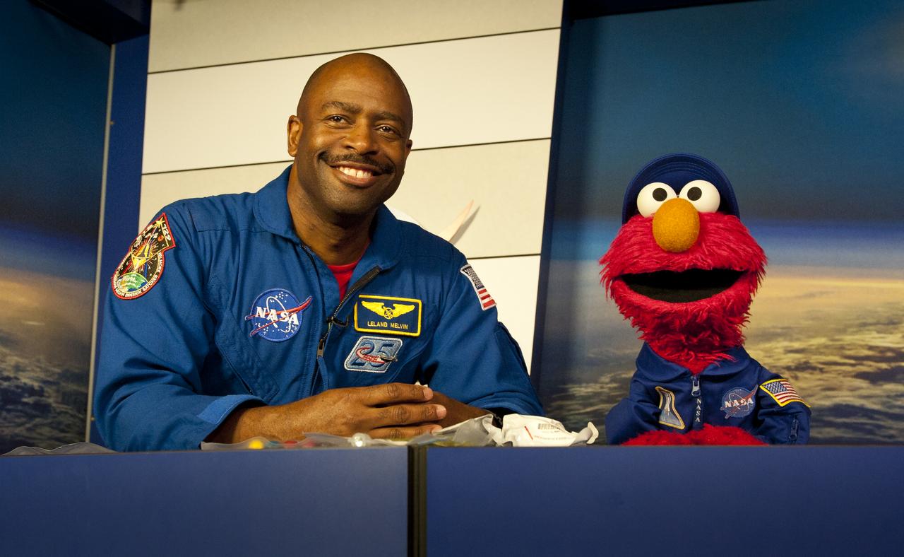 NASA Associate Administrator for Education and former astronaut Leland Melvin teaches the ABC's of living and working in space to Sesame Street's Elmo at NASA's Kennedy Space Center, Wednesday, July 6, 2011 in Cape Canaveral, FL.  The pair discussed nutrition, exercise, hygiene in orbit.  They also chatted about the features of the space shuttle and the various suits that astronauts wear.  Photo Credit:  (NASA/Carla Cioffi)