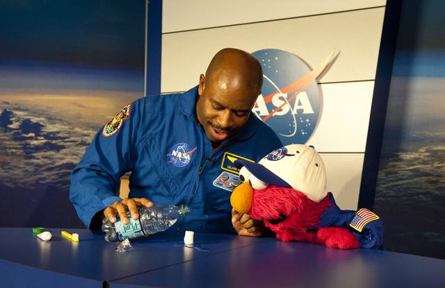 NASA image: Former Astronaut Leland Melvin speaks with Elmo