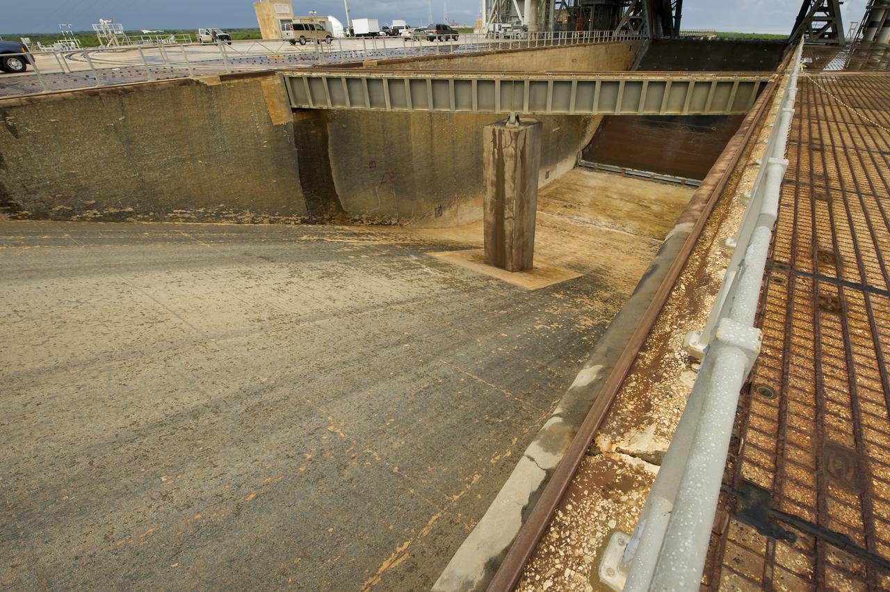 The flame trench underneath the space shuttle Atlantis at pad 39a is seen on Thursday, July 7, 2011 at the NASA Kennedy Space Center in Cape Canaveral, Fla.  Space shuttle Atlantis is set to liftoff Friday, July 8, on the final flight of the shuttle program, STS-135, a 12-day mission to the International Space Station.  Photo Credit: (NASA/Bill Ingalls)