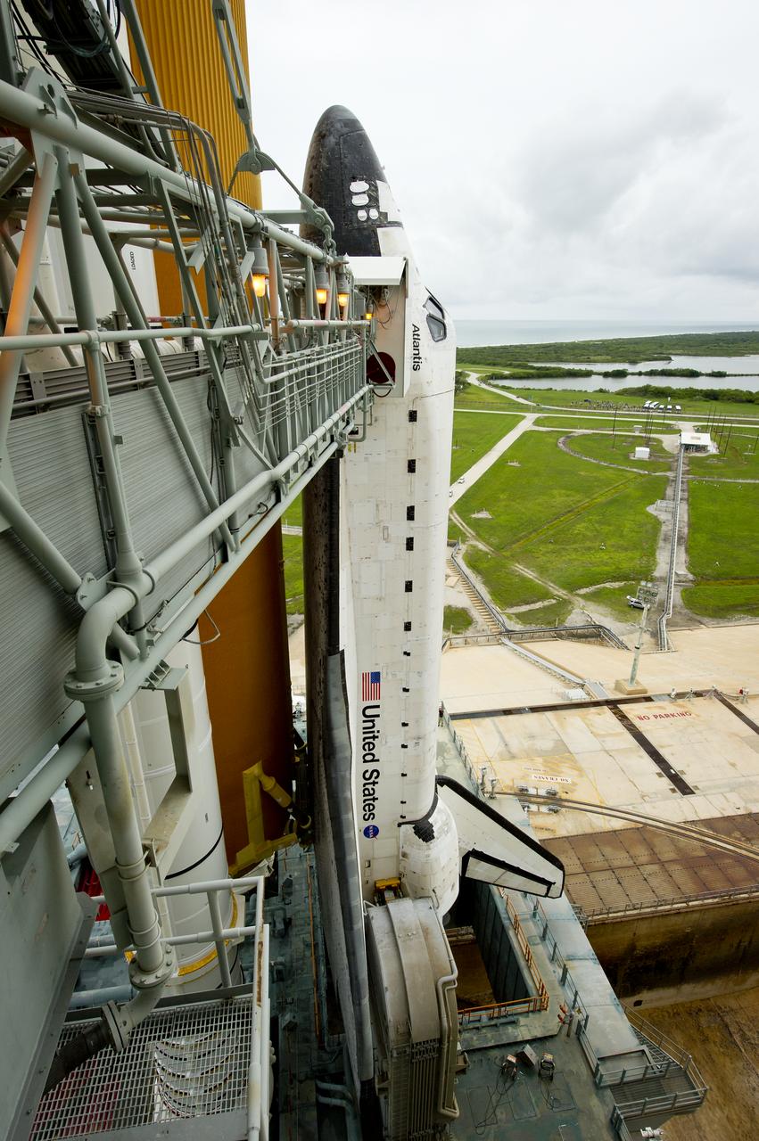The space shuttle Atlantis is revealed as the rotating service structure (RSS) is rolled back at launch pad 39a on Thursday, July 7, 2011 at the NASA Kennedy Space Center in Cape Canaveral, Fla.  Atlantis is set to liftoff Friday, July 8, on the final flight of the shuttle program, STS-135, a 12-day mission to the International Space Station.  Photo Credit: (NASA/Bill Ingalls)