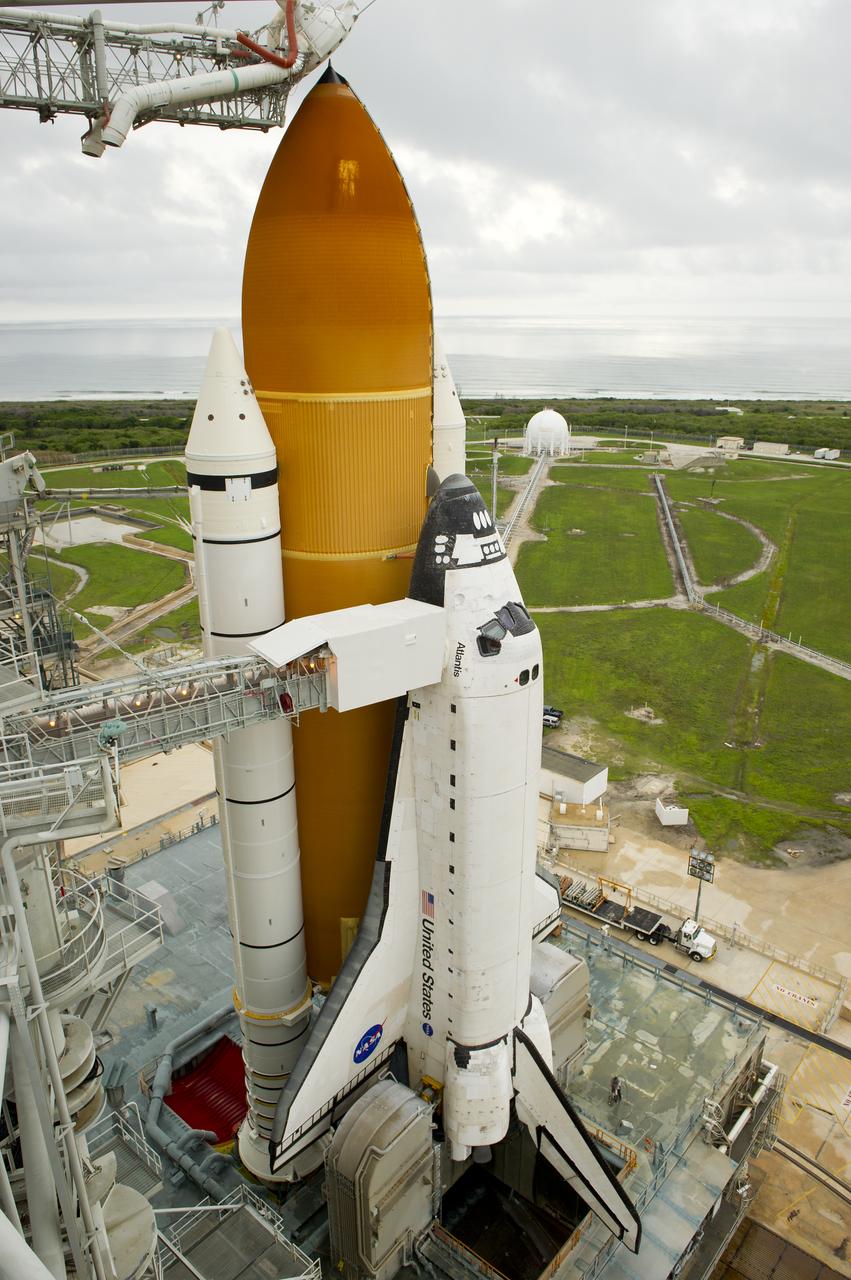 The space shuttle Atlantis is revealed as the rotating service structure (RSS) is rolled back at launch pad 39a on Thursday, July 7, 2011 at the NASA Kennedy Space Center in Cape Canaveral, Fla.  Atlantis is set to liftoff Friday, July 8, on the final flight of the shuttle program, STS-135, a 12-day mission to the International Space Station.  Photo Credit: (NASA/Bill Ingalls)