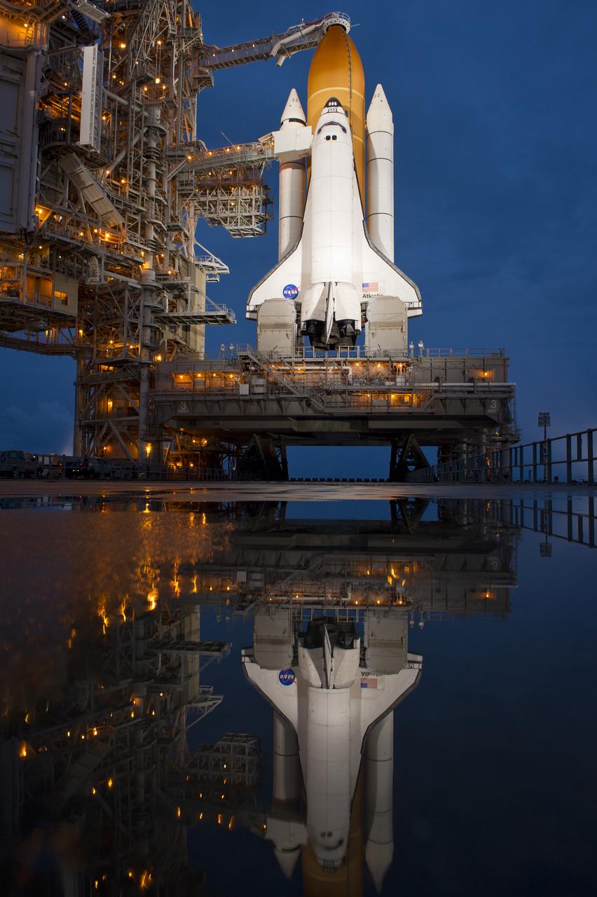 The space shuttle Atlantis is seen shortly after the rotating service structure (RSS) was rolled back at launch pad 39a, Thursday, July 7, 2011 at the NASA Kennedy Space Center in Cape Canaveral, Fla.  Atlantis is set to liftoff Friday, July 8, on the final flight of the shuttle program, STS-135, a 12-day mission to the International Space Station.  Photo Credit: (NASA/Bill Ingalls)