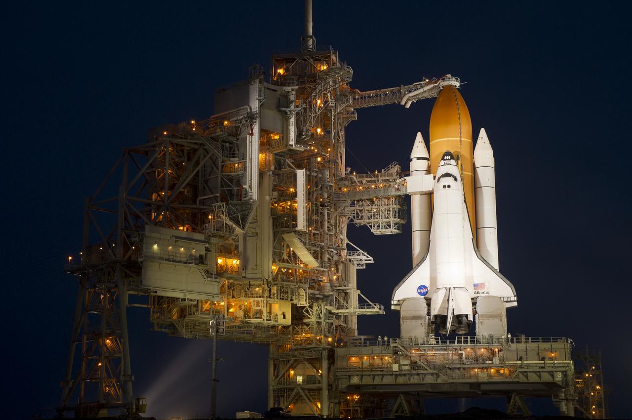 The space shuttle Atlantis is seen shortly after the rotating service structure (RSS) was rolled back at launch pad 39a, Thursday, July 7, 2011 at the NASA Kennedy Space Center in Cape Canaveral, Fla.  Atlantis is set to liftoff Friday, July 8, on the final flight of the shuttle program, STS-135, a 12-day mission to the International Space Station.  Photo Credit: (NASA/Bill Ingalls)