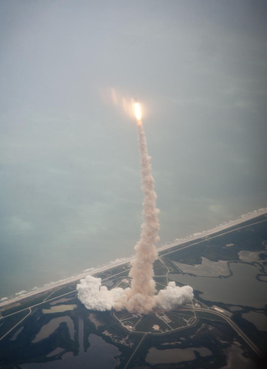 Space shuttle Atlantis is seen through the window of a Shuttle Training Aircraft (STA) as it launches from launch pad 39A at Kennedy Space Center on the STS-135 mission, Friday, July 8, 2011 in Cape Canaveral, Fla. Atlantis launched on the final flight of the shuttle program on a 12-day mission to the International Space Station. The STS-135 crew will deliver the Raffaello multipurpose logistics module containing supplies and spare parts for the space station. Photo Credit: (NASA/Dick Clark)