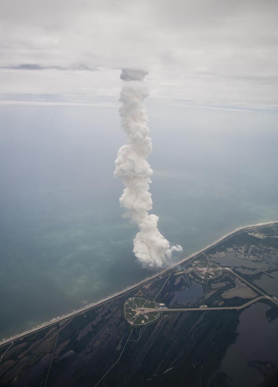 The exhaust plume from space shuttle Atlantis is seen through the window of a Shuttle Training Aircraft (STA) as it launches from launch pad 39A at the Kennedy Space Center on the STS-135 mission, Friday, July 8, 2011 in Cape Canaveral, Fla. Atlantis launched on the final flight of the shuttle program on a 12-day mission to the International Space Station. The STS-135 crew will deliver the Raffaello multipurpose logistics module containing supplies and spare parts for the space station. Photo Credit: (NASA/Dick Clark)