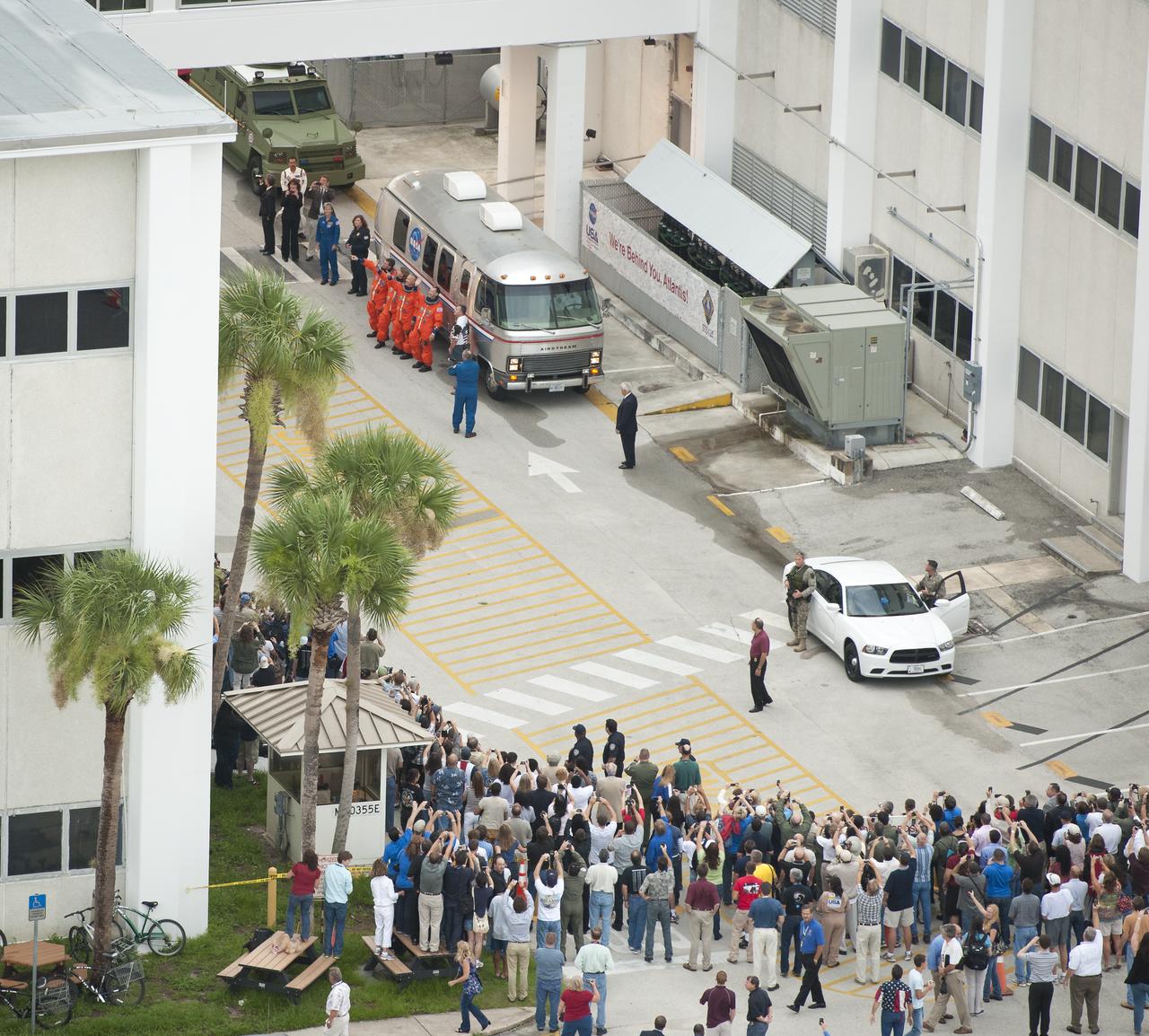The STS-135 crew; Chris Ferguson, commander; Doug Hurley, pilot; Rex Walheim and Sandy Magnus, both mission specialists stop and pose for photographers before boarding the Astrovan that will take them to launch pad 39A for the launch of the space shuttle Atlantis on Friday, July 8, 2011 at the NASA Kennedy Space Center in Cape Canaveral, Fla.  The launch of Atlantis, STS-135, is the final flight of the shuttle program, a 12-day mission to the International Space Station.  Photo Credit: (NASA/Bill Ingalls)