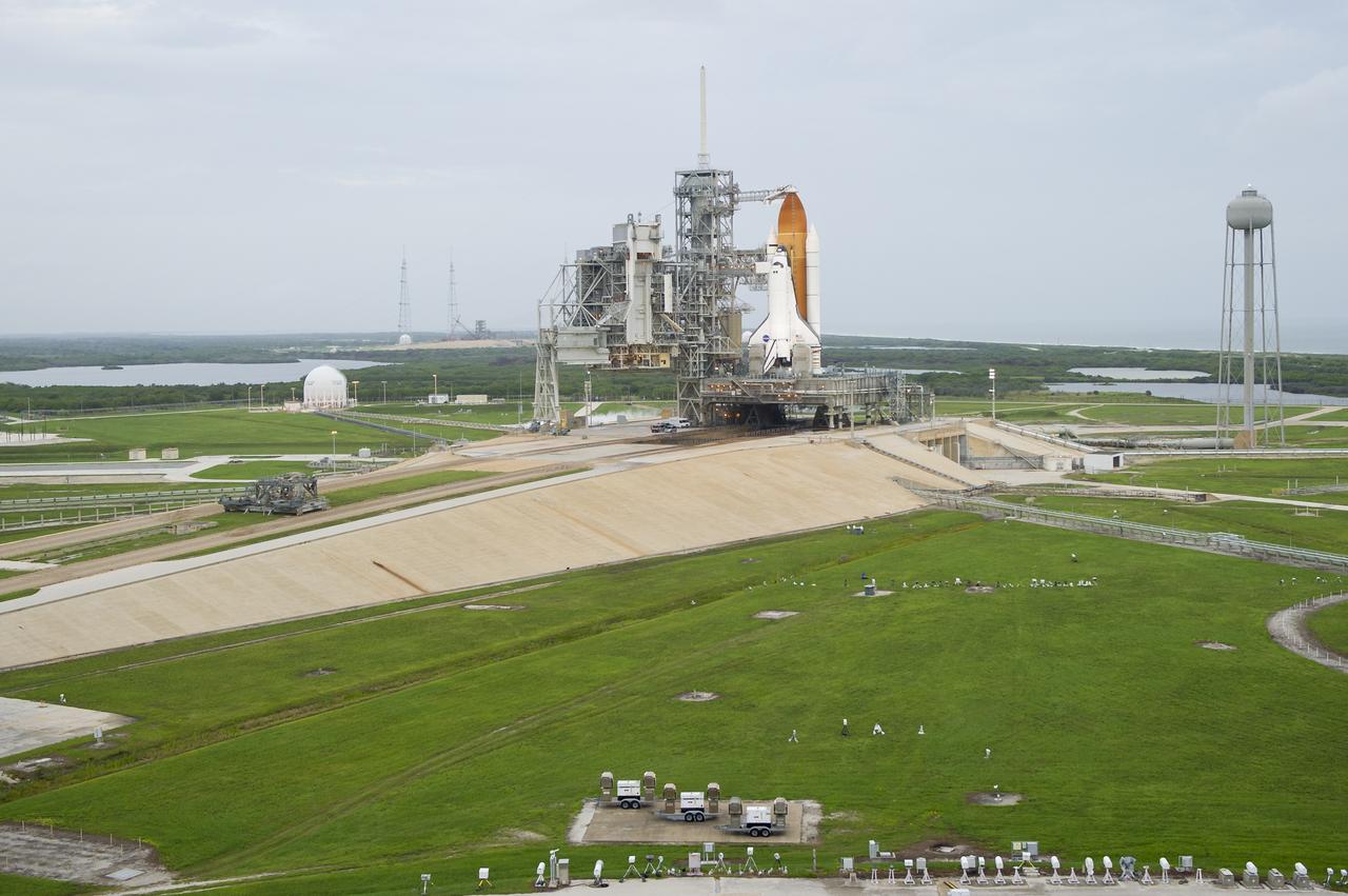Space shuttle Atlantis is seen on launch pad 39a moments before the STS-135 crew arrives for their launch, Friday, July 8, 2011, at the NASA Kennedy Space Center in Cape Canaveral, Fla. The launch of Atlantis, STS-135, is the final flight of the shuttle program, a 12-day mission to the International Space Station.  Photo Credit: (NASA/Bill Ingalls)
