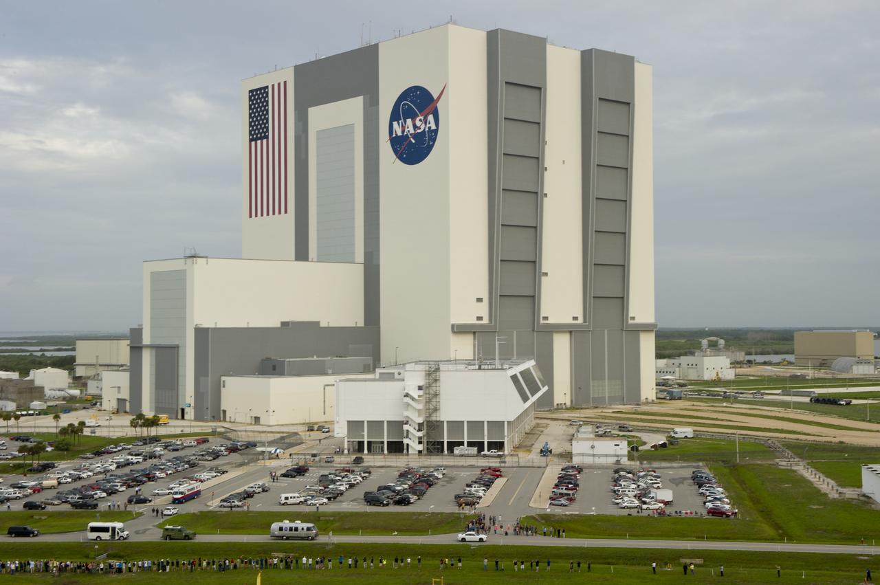 The Astrovan carrying the STS-135 crew; Chris Furgeson, commander, Doug Hurley, pilot, and mission specialists Rex Walheim and Sandy Mangus, rolls past the Vehicle Assembly Building (VAB) and Launch Control Center (LCC), on its way to launch pad 39a and space shuttle Atlantis, Friday, July 8, 2011, at Kennedy Space Center in Cape Canaveral, Fla. The launch of Atlantis, STS-135, is the final flight of the shuttle program, a 12-day mission to the International Space Station.  Photo Credit: (NASA/Bill Ingalls)