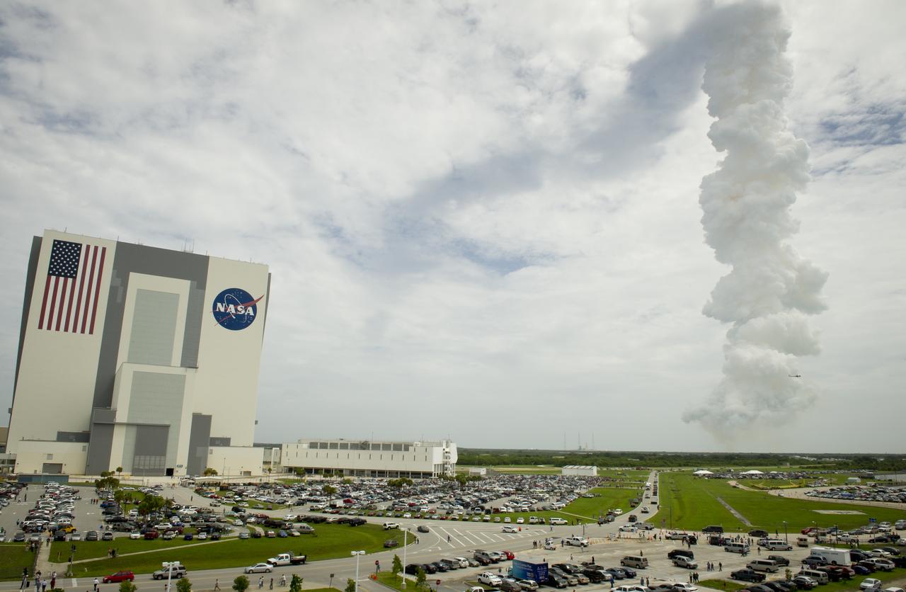 The exhaust plume from space shuttle Atlantis is seen to the left of the Vehicle Assembly Building, Friday, July 8, 2011 in Cape Canaveral, Fla. Atlantis launched on the final flight of the shuttle program on a 12-day mission to the International Space Station. The STS-135 crew will deliver the Raffaello multipurpose logistics module containing supplies and spare parts for the space station. Photo Credit: (NASA/Carla Cioffi)