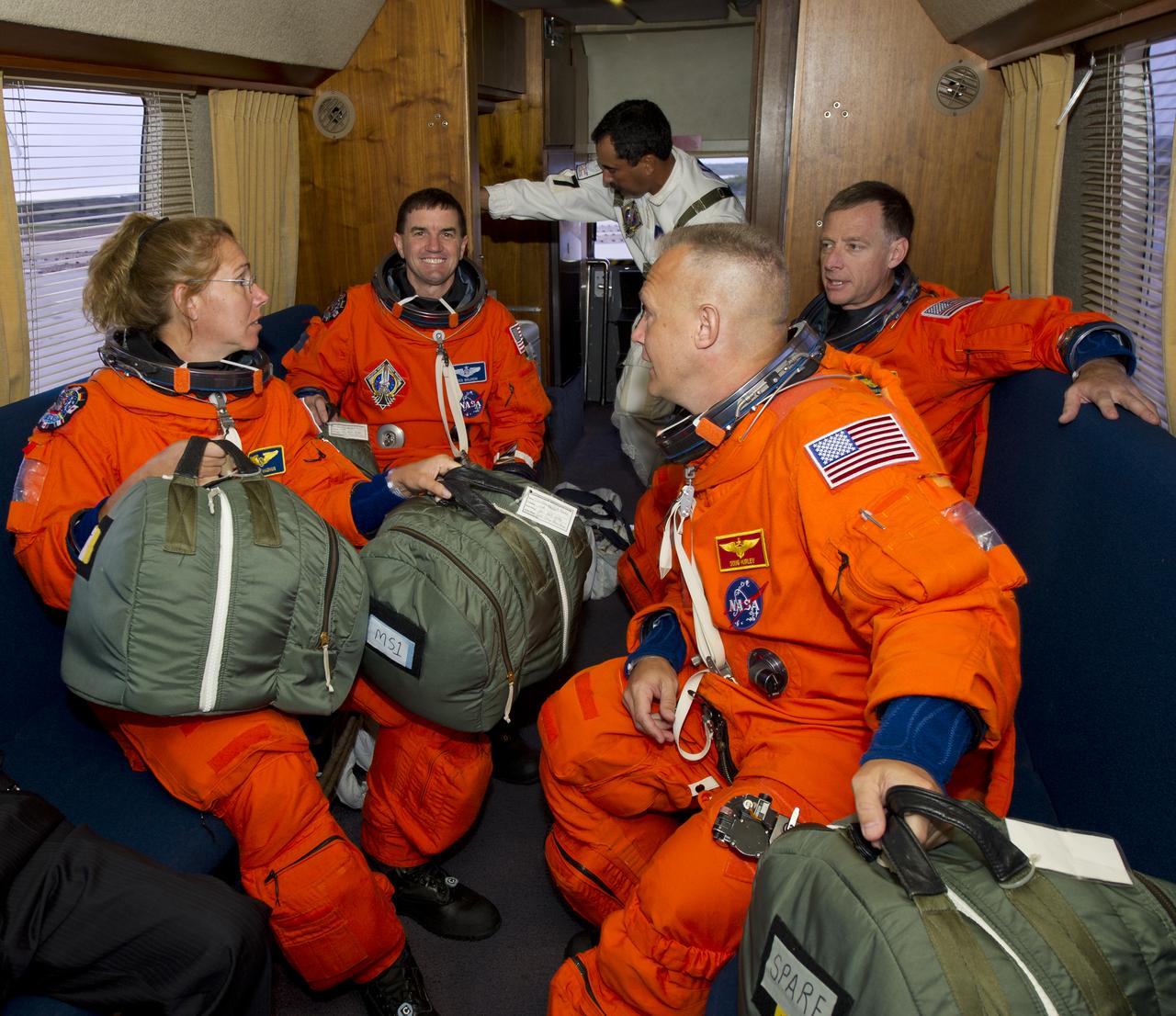 The STS-135 crew, clockwise: Sandra Magnus, mission specialist; Rex Walheim, mission specialist; Chris Ferguson, commander and Doug Hurley, pilot are seen in the Astrovan as they ride to launch pad 39A to board space shuttle Atlantis on Friday, July 8, 2011, at the Kennedy Space Center in Cape Canaveral, Fla.  The launch of Atlantis, STS-135, is the final flight of the shuttle program, a 12-day mission to the International Space Station.  Photo Credit: (NASA/Jerry Ross)