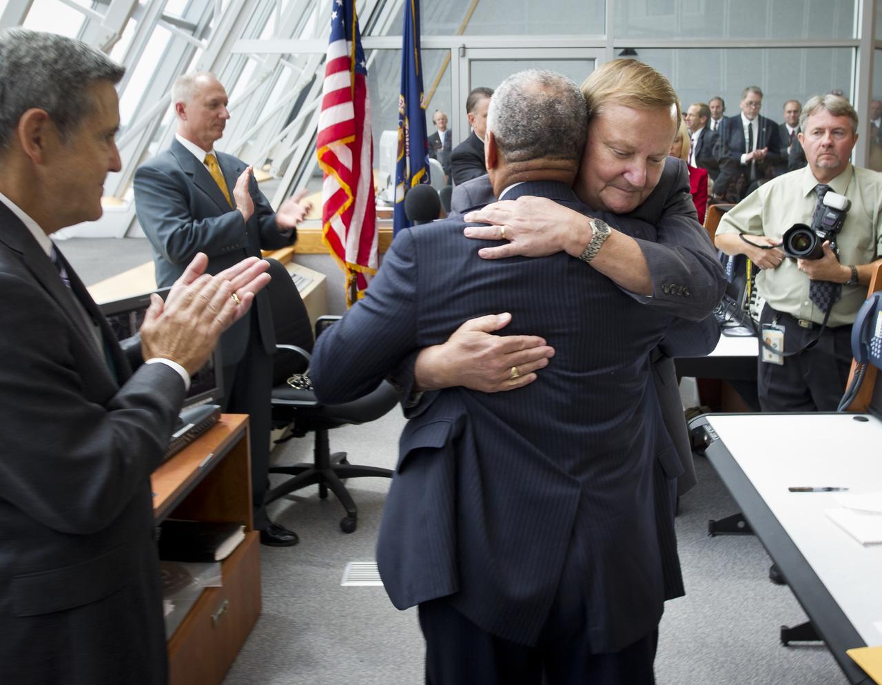 NASA Administrator Charles Bolden congratulates Launch Director Michael Leinbach, facing camera, in Firing Room Four of the Launch Control Center (LCC) shortly after the space shuttle Atlantis, STS-135, launched on Friday, July 8, 2011, in Cape Canaveral, Fla. The launch of Atlantis, STS-135, is the final flight of the shuttle program, a 12-day mission to the International Space Station.  Photo Credit: (NASA/Bill Ingalls)