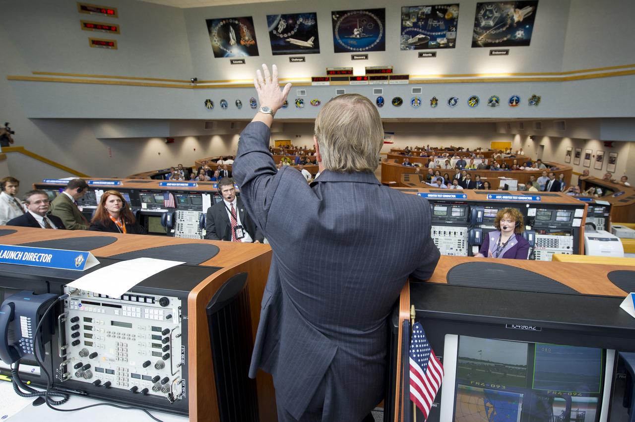 NASA Launch Director Michael Leinbach congratulates the launch team in the NASA Kennedy Space Center Firing Room Four of the Launch Control Center (LCC) shortly after the space shuttle Atlantis, STS-135, launched on Friday, July 8, 2011, in Cape Canaveral, Fla. The launch of Atlantis, STS-135, is the final flight of the shuttle program, a 12-day mission to the International Space Station.  Photo Credit: (NASA/Bill Ingalls)