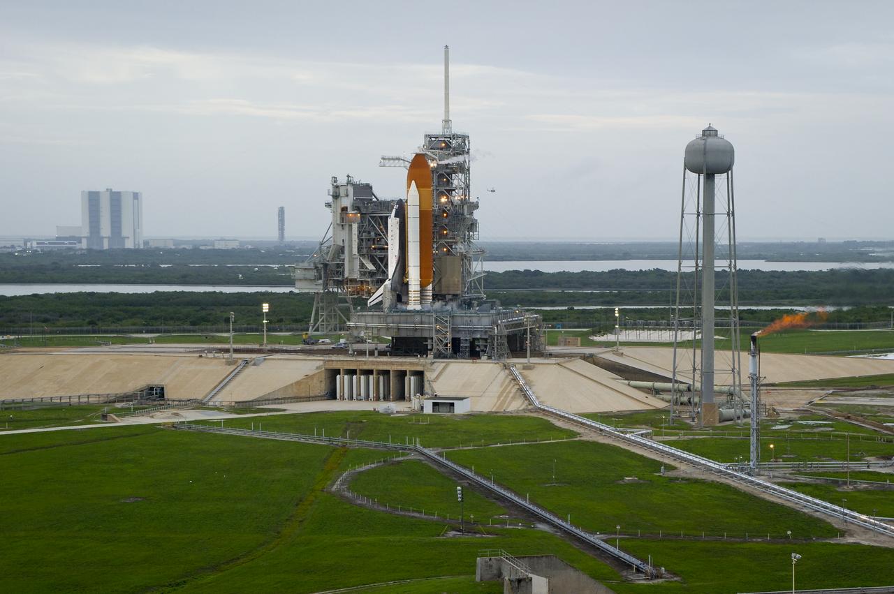 Space shuttle Atlantis is seen on launch pad 39a moments before the STS-135 crew arrives for their launch, Friday, July 8, 2011, at the NASA Kennedy Space Center in Cape Canaveral, Fla. The launch of Atlantis, STS-135, is the final flight of the shuttle program, a 12-day mission to the International Space Station.  Photo Credit: (NASA/Bill Ingalls)