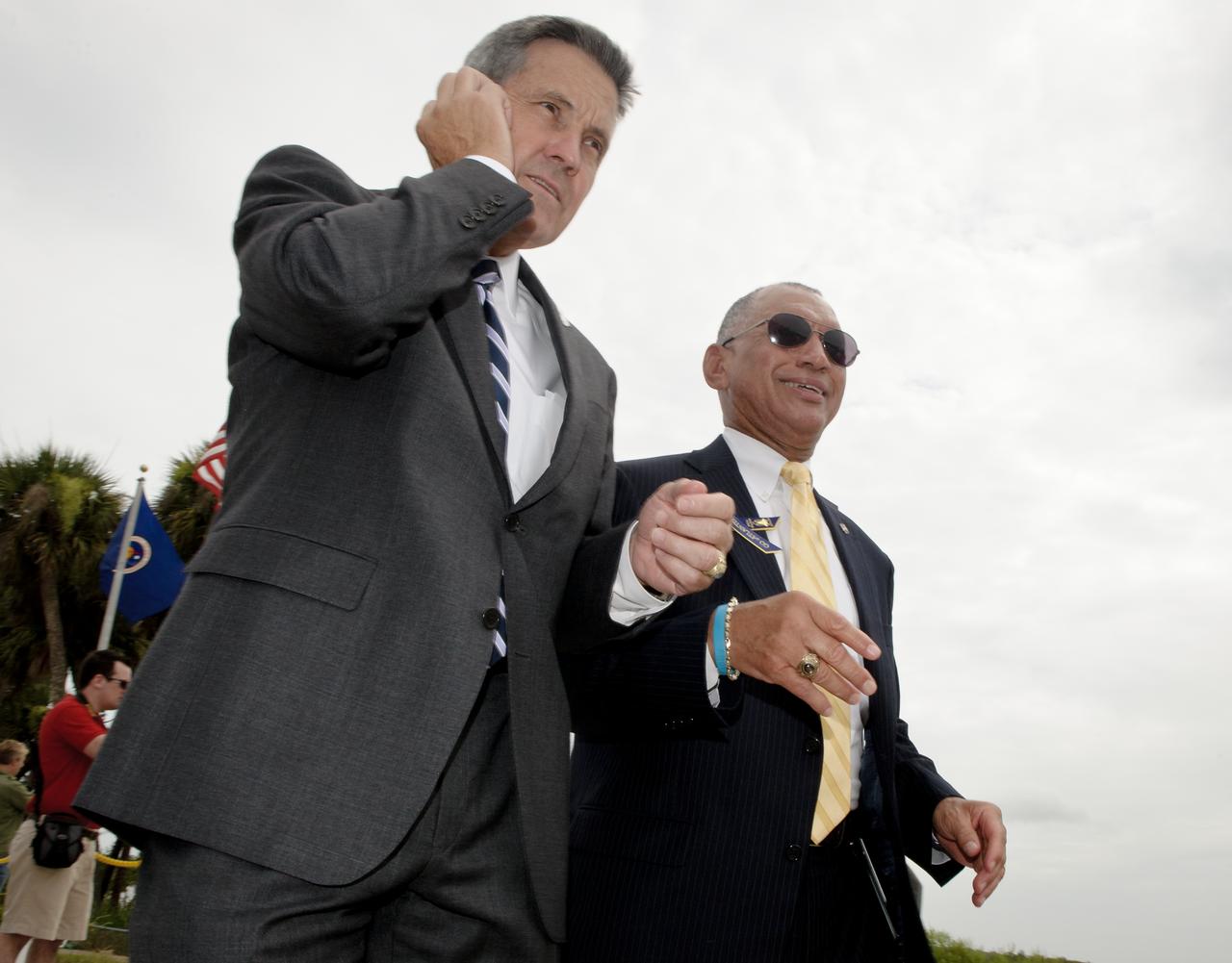 NASA Administrator Charles Bolden, right, and NASA Kennedy Space Center Director Bob Cabana, left, quickly walk to the viewing bleachers at the NASA Kennedy Space Center Banana Creek viewing site in order to say a view words with visitors before they head to the Launch Control Center (LCC) for the planned launch of the space shuttle Atlantis from pad 39A on Friday, July 8, 2011, in Cape Canaveral, Fla. The launch of Atlantis, STS-135, is the final flight of the shuttle program, a 12-day mission to the International Space Station.  Photo Credit: (NASA/Bill Ingalls)