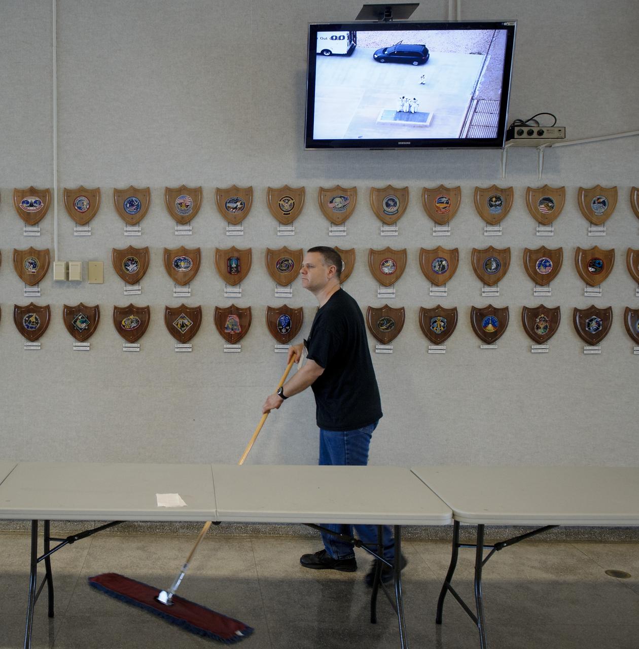 NASA Kennedy Space Center worker Dwayne Hutcheson sweeps the Launch Control Center (LCC) lobby floor in preparation for the post launch tradition of corn bread and beans after a successful launch of the space shuttle Atlantis from pad 39A on Friday, July 8, 2011, in Cape Canaveral, Fla. The launch of Atlantis, STS-135, is the final flight of the shuttle program, a 12-day mission to the International Space Station.  Photo Credit: (NASA/Bill Ingalls)