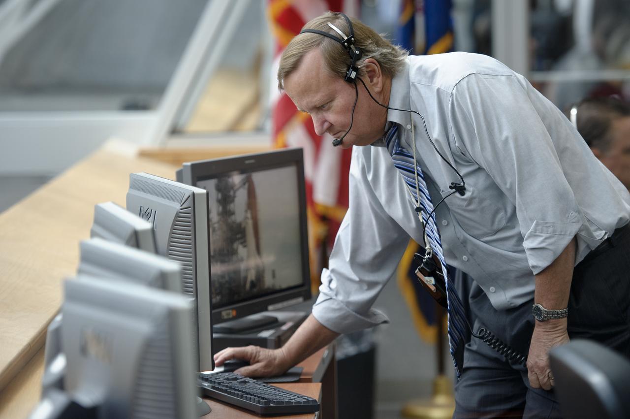 NASA Shuttle Launch Director Michael Leinbach monitors the launch countdown from Firing Room Four of the Launch Control Center (LCC) at NASA's Kennedy Space Center on Friday, July 8, 2011, in Cape Canaveral, Fla. The launch of Atlantis, STS-135, is the final flight of the shuttle program, a 12-day mission to the International Space Station.  Photo Credit: (NASA/Bill Ingalls)