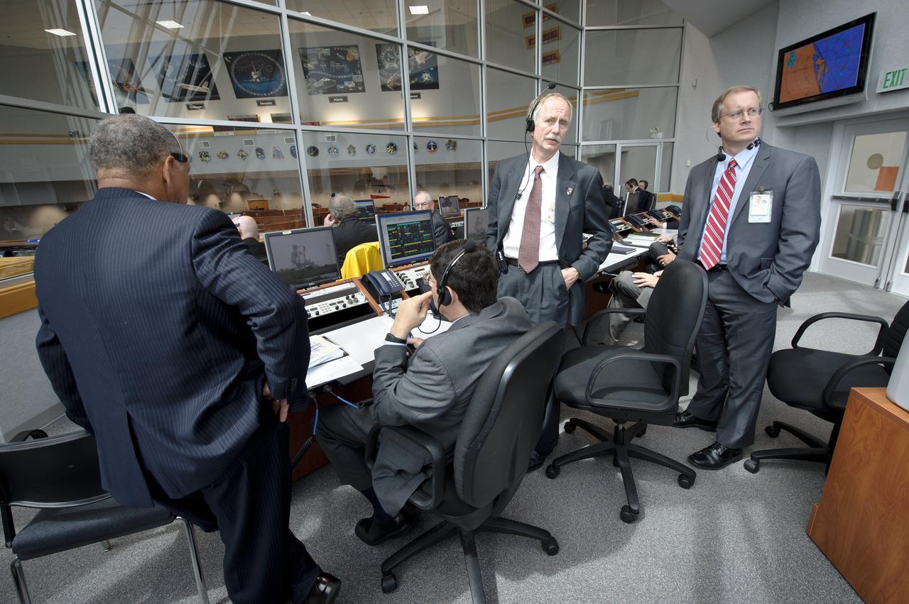 NASA Associate Administrator for Space Operations William Gerstenmaier, standing left, Manager, Space Shuttle Program Office John Shannon, standing right, and other management look on from Firing Room Four of the NASA Kennedy Space Center Launch Control Center (LCC) as they monitor the weather and countdown to the launch of the space shuttle Atlantis on Friday, July 8, 2011, in Cape Canaveral, Fla. The launch of Atlantis, STS-135, is the final flight of the shuttle program, a 12-day mission to the International Space Station.  Photo Credit: (NASA/Bill Ingalls)