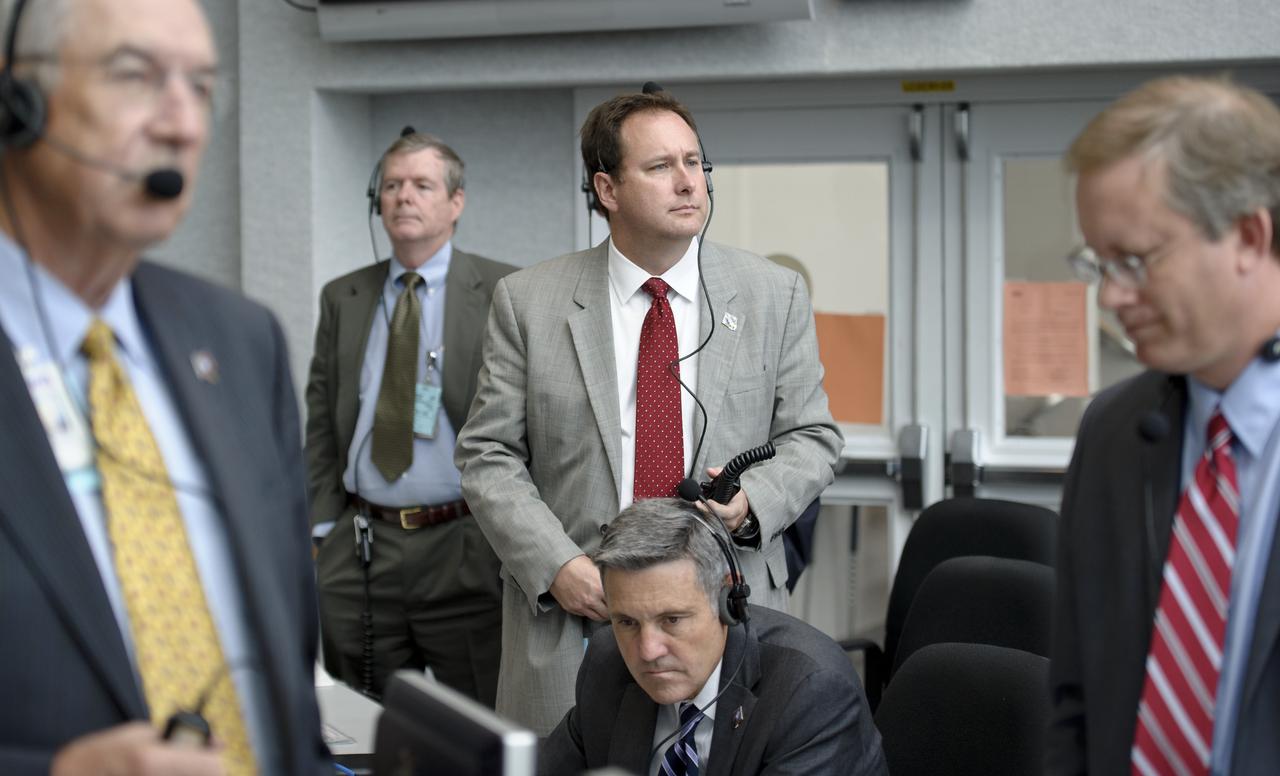 NASA Marshall Space Flight Center Director Robert Lightfoot Jr., standing center, and other management looks on from Firing Room Four of the NASA Kennedy Space Center Launch Control Center (LCC) as he and the launch team monitor the weather and countdown to the launch of the space shuttle Atlantis on Friday, July 8, 2011, in Cape Canaveral, Fla. The launch of Atlantis, STS-135, is the final flight of the shuttle program, a 12-day mission to the International Space Station.  Photo Credit: (NASA/Bill Ingalls)