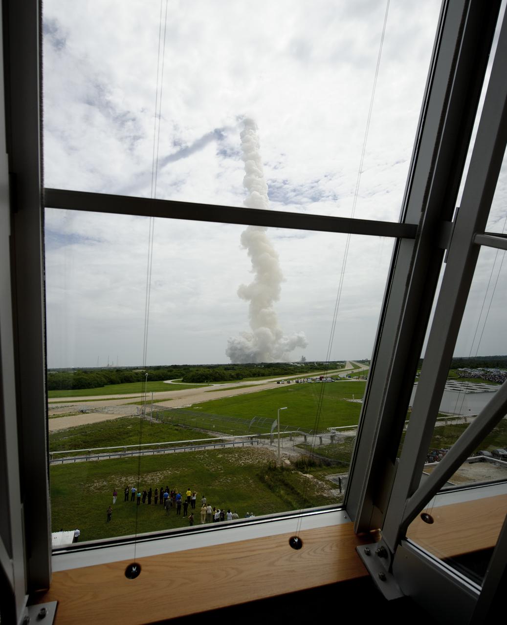 The exhaust plume from space shuttle Atlantis is seen from Firing Room Four of the Launch Control Center (LCC) as space shuttle Atlantis launches from pad 39A on Friday, July 8, 2011, in Cape Canaveral, Fla. The launch of Atlantis, STS-135, is the final flight of the shuttle program, a 12-day mission to the International Space Station.  Photo Credit: (NASA/Bill Ingalls)