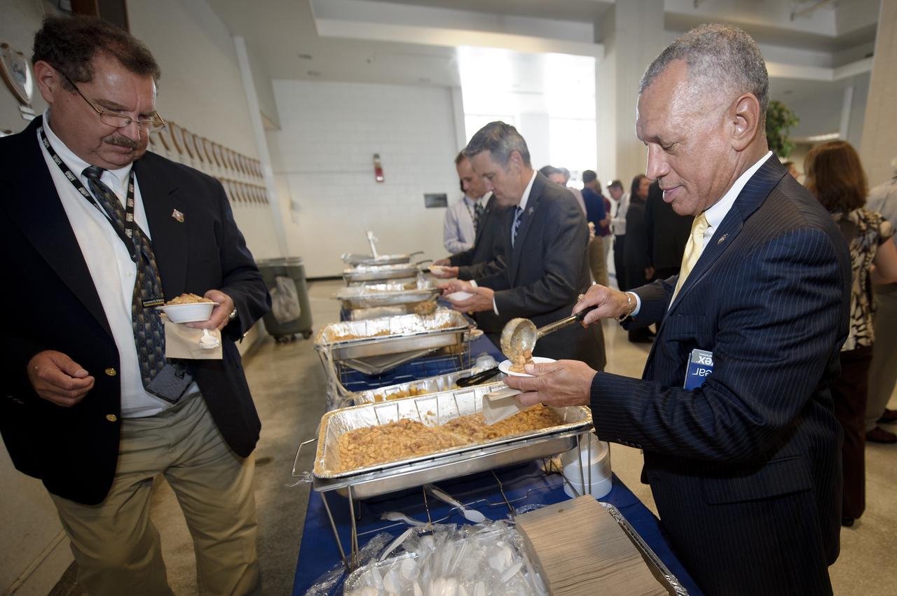 NASA Administrator Charles Bolden, right, participates in the post launch traditional beans and cornbread at the NASA Kennedy Space Center, Launch Control Center (LCC) shortly after the space shuttle Atlantis, STS-135, launched on Friday, July 8, 2011, in Cape Canaveral, Fla. The launch of Atlantis is the final flight of the shuttle program, a 12-day mission to the International Space Station.  Photo Credit: (NASA/Bill Ingalls)