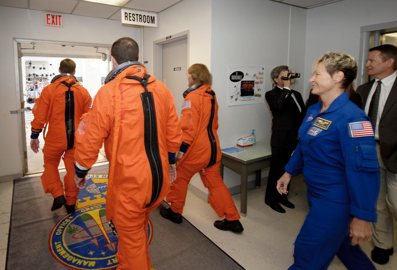 The crew of STS-135 is seen as they depart the NASA Kennedy Space Center, Operations and Checkout Building and get into the Astrovan for launch pad 39A, on Friday, July 8, 2011 in Cape Canaveral, Fla. The launch of Atlantis, STS-135, is the final flight of the shuttle program, a 12-day mission to the International Space Station.  Photo Credit:  (NASA/Jerry Ross)