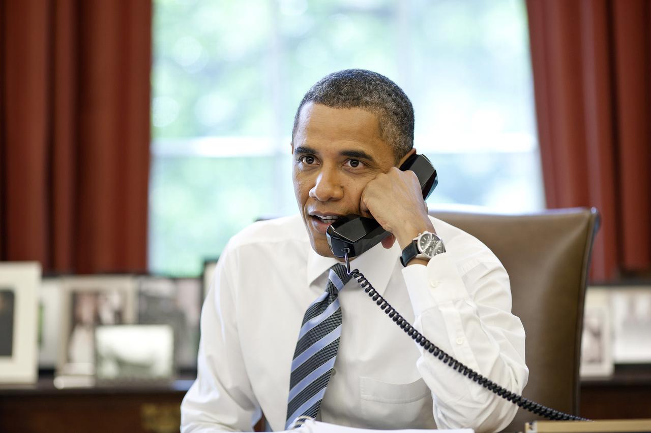 President Barack Obama talks with the crews of the Space Shuttle Atlantis and the International Space Station during a phone call in the Oval Office, Friday, July 15, 2011, in Washington. (Official White House Photo by Pete Souza)